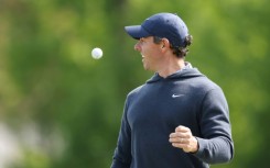 Four-time major winner Rory McIlroy of Northern Ireland laughs during a practice round for the 105th PGA Championship at Oak Hill