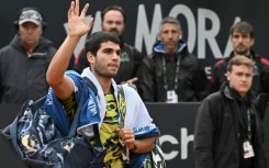 Carlos Alcaraz waves as he leaves the court in Rome after a defeat just two weeks before the French Open where he will be top seed