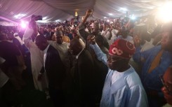 Nigerian ruling party candidate Bola Tinubu acknowledges supporters in Abuja on March 1, 2023 during celebrations on his election win in Abuja