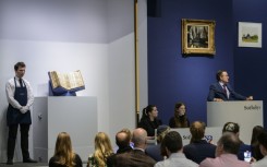 Sotheby’s auctioneer Benjamin Doller (R) takes bids during the Codex Sassoon sale at Sotheby’s in New York City on May 17, 2023