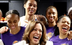 US Vice President Kamala Harris (center) laughs with Brittney Griner (top) and other Phoenix Mercury players before their game in Los Angeles on Friday