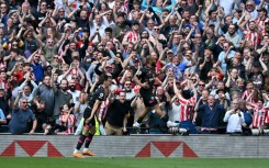 Brentford's Bryan Mbeumo (C) celebrates after scoring against Tottenham