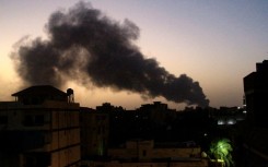 Smoke rises over Khartoum on Friday as air strikes and artillery exchanges grip the Sudanese capital