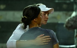 Champion's embrace: Elena Rybakina (right) consoles Anhelina Kalinina 