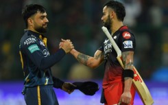 Star quality: Virat Kohli is congratulated by Gujarat's Rashid Khan after making his century