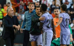 Real Madrid's Brazilian forward Vinicius Junior (3R) confronts Valencia's bench