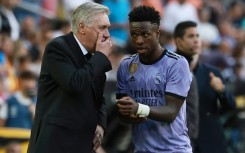 Real Madrid forward Vinicius Junior listens to coach Carlo Ancelotti (L) during the Valencia defeat in which he was racially abused