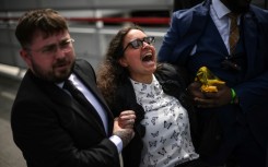 More than 100 activists disrupted the start of the shareholders' meeting before being escorted out by security