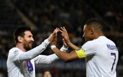 Lionel Messi celebrates with Kylian Mbappe after scoring for Paris Saint-Germain as they drew 1-1 in Strasbourg on Saturday to clinch the Ligue 1 title