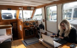Amy Whetzel works in her boat, Miranda, anchored in Mayo, Maryland, about an hour's drive form the US capital