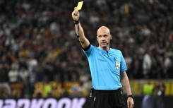 English referee Anthony Taylor shows a yellow card during the UEFA Europa League final