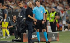 AS Roma coach Jose Mourinho remonstrates with fourth official Michael Oliver during the  Europa League final