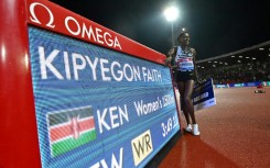 Kenya's Faith Kipyegon poses after winning the women's 1500m in a new world record of 3:49.11