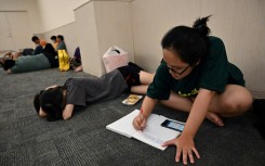 Student Nguyen Minh Thu works on an assignment in a room in a mall set aside for people seeking to escape from high outdoor temperatures