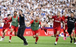Mark van Bommel (3rdL) and Toby Alderweireld (2ndR) celebrate the title win