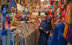 Women shop for jewellery at a market in Peshawar on June 8, a day before Pakistan releases its budget