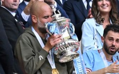 Manchester City boss Pep Guardiola holding the FA Cup after his team beat Manchester United in last week's final
