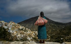 Lord of all she surveys: a sculpture of a woman in traditional costume in Olympos on the Greek island of Karpathos