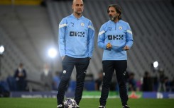 Pep Guardiola (L) alongside Manchester City's Spanish fitness coach Lorenzo Buenaventura as their team train at the Ataturk Olympic Stadium in Istanbul on Friday