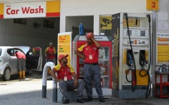 Attendants wait for customers at a petrol station in Rawalpindi on Friday. Soaring energy prices have been one of the biggest drivers of inflation in Pakistan