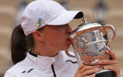 Third time: Iga Swiatek kisses the trophy after Saturday's win