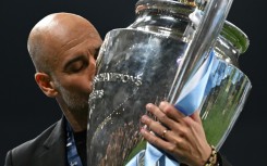 Pep Guardiola kisses the European Cup trophy after Manchester City's Champions League win