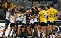 Brumbies players celebrate their victory over the Hurricanes