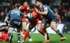 Munster lock Jean Kleyn (R) tackles Toulouse scrum-half Antoine Dupont during a 2023 Champions Cup match.
