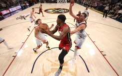 Miami's Jimmy Butler drives to the basket against Denver's Nikola Jokic but the Heat fell in game five of the NBA Finals as the Nuggets took the title