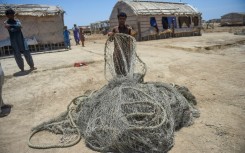 Villagers wait to be evacuated to government relief camps before the arrival of the cyclone,  in Sujawal district, Sindh province