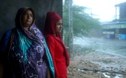 Cyclone Biparjoy tore down power poles and uprooted trees after pummelling the Indian coastline, though the storm was weaker than feared 
