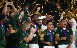 Captain Siya Kolisi (C) holds the Webb Ellis Cup after South Africa beat England in the 2019 Rugby World Cup final in Japan. 