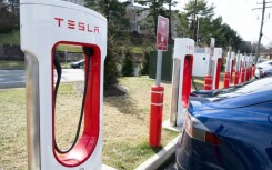 The embrace of Tesla's electric vehicle charging network has raised questions about whether it will supplant a rival system and become the national standard