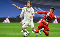 Real Madrid's Croatian midfielder Luka Modric (L) will stay in the Spanish capital for another season