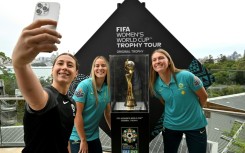 Australia's Sarah Hunter, Courtney Nevin and Clare Hunt (l-r) pose with the Women's World Cup trophy in Sydney