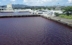 A leak filled a port area in the city of Nago with the luridly coloured water
