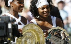 Family ties: Venus Williams with sister  Serena after winning the 2008 Wimbledon final 