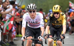Tadej Pogacar (L) tailed by defending champion Jonas Vingegaard on stage one of the Tour de France