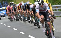 Tadej Pogacar riding downhill at the head of the lead clique 