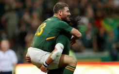 Springbok Willie le Roux (L) celebrates scoring against New Zealand during the 2022 Rugby Championship
