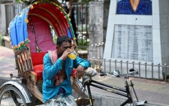 A rickshaw puller quenches his thirst with a juice during a heatwave in Dhaka, Bangladesh on June 6, 2023