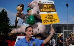 United Parcel Services (UPS) workers walk a 'practice picket line' on July 7, 2023, in the Queens borough of New York City, ahead of a possible UPS strike