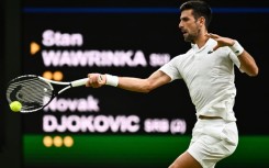 Name game: Novak Djokovic returns the ball to Stan Wawrinka 