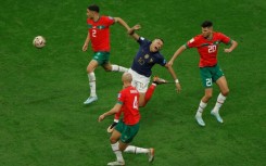 France superstar Kylian Mbappe (C) is surrounded by Moroccans during a 2022 World Cup semi-final in Qatar