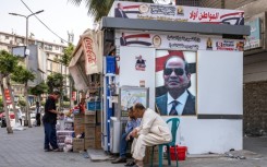 Portraits of Egypt's President Abdel Fattah al-Sisi adorn a stall in central Cairo for the government-sponsored "Citizen First" initiative, which aims to sell basic goods at reduced prices
