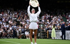 Champion: Marketa Vondrousova celebrates with the Venus Rosewater Dish trophy 