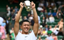 Japan's Tokito Oda with the Wimbledon wheelchair singles trophy