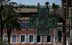 Tunisians wade in the Mediterranean sea waters at a beach off La Goulette suburb of Tunis 