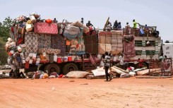 A truck carrying mattresses and pieces of furniture parked along the road connecting Sudan's capital to the city of Wad Madani