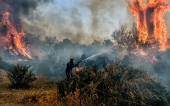 As Greece announced the restrictions, firefighters were still battling wildfires west of Athens
